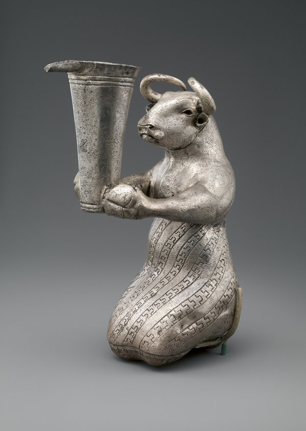 Kneeling bull holding a spouted vessel