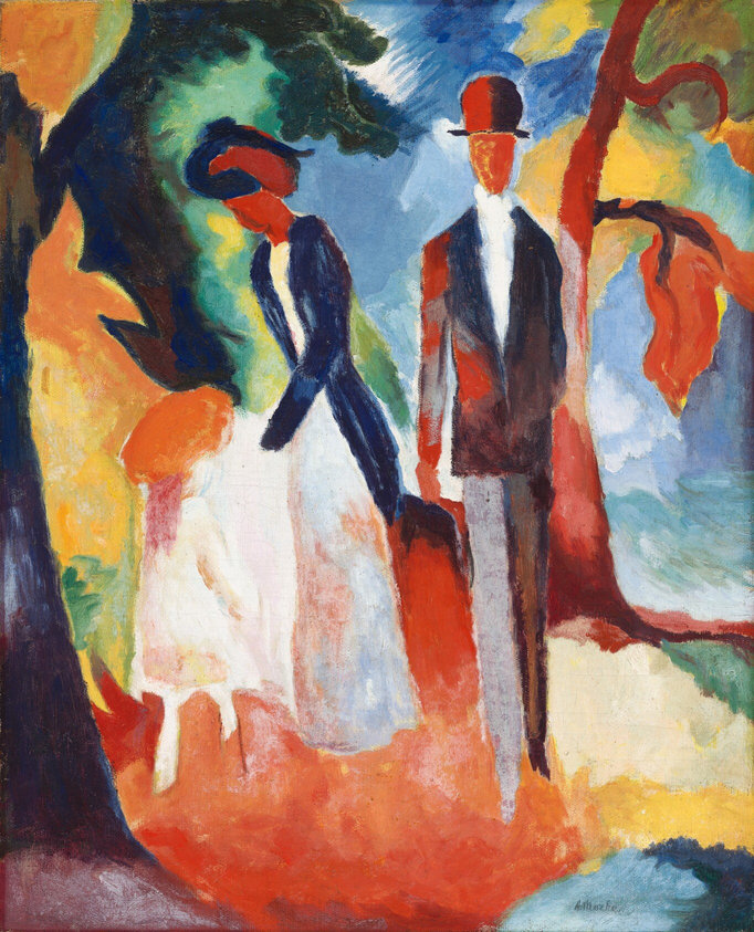 In this painting, abstract shapes and bright colors give the impression of two tall people standing outdoors. The people are in formal attire, depicted with vibrant colors and simplified forms: a man on the right has a square head with dark orange skin and no facial features. He appears to wear a black suit jacket over a white shirt with gray pants and a bowler hat. He stands next to another person on the left who appears to be a woman with dark red skin and no facial features wearing a blue coat over a white dress, with something on her head that may be a dark, wide-brimmed hat. The woman is reaching down to the left towards an area of the painting with white, pink, and orange shapes, which may depict a small child facing away from us, with white skin and clothes, light pink hair, and an orange hat. In the background, shapes resembling twisted brown and red tree trunks add organic lines, along with areas of green, orange, and yellow. Areas of blue suggest a sky behind the trees, and the ground under the people is mostly orange with areas of yellow, green, and blue.