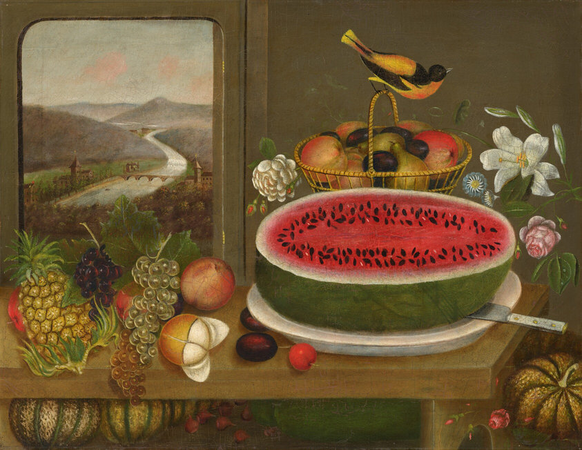 In this painting, a large half watermelon with vibrant red flesh and black seeds sits at the center of a white plate with a silver knife on top of it. Surrounding it on the long wooden table are various fruits, such as a yellow pineapple, red and green grapes, dark red plums, pink peaches, and a partially peeled orange. Below the table are some pumpkins or squash, as well as what could be figs or radishes. A yellow-and-black bird is perched on the handle of a yellow basket of mixed fruit placed behind the watermelon. Around the basket are white and pink flowers. In the background, on the left of the painting, a window reveals a scenic landscape featuring a winding river cutting through a green valley and dark, tree-filled hills below a light blue sky with faint pink clouds. The wall behind the table is a plain gray color.